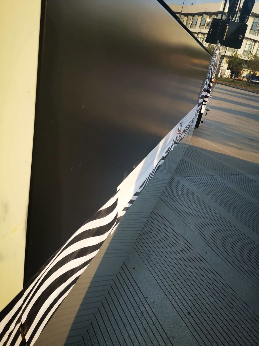 Finished bus exterior side panel surface viewed in field conditions.